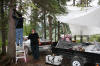 Two people put up tarps...