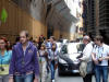 People, cars, and horses all sharing the same narrow streets